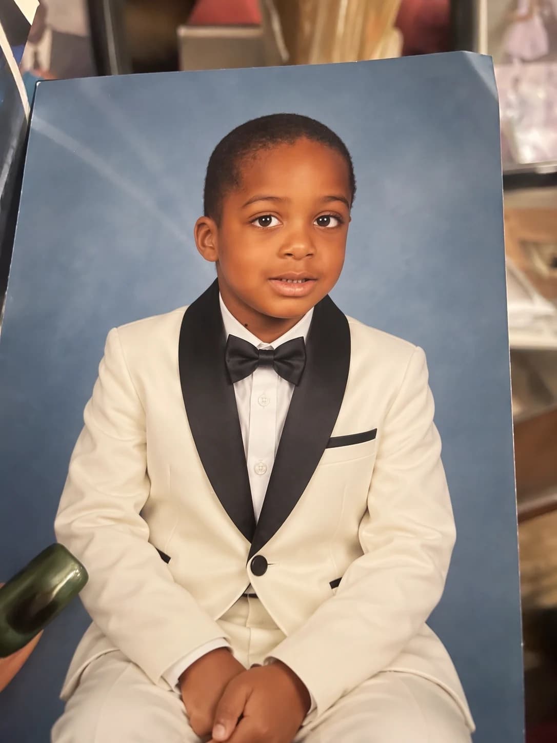 OpenAI image-editing example: a printed child portrait with an ivory tuxedo